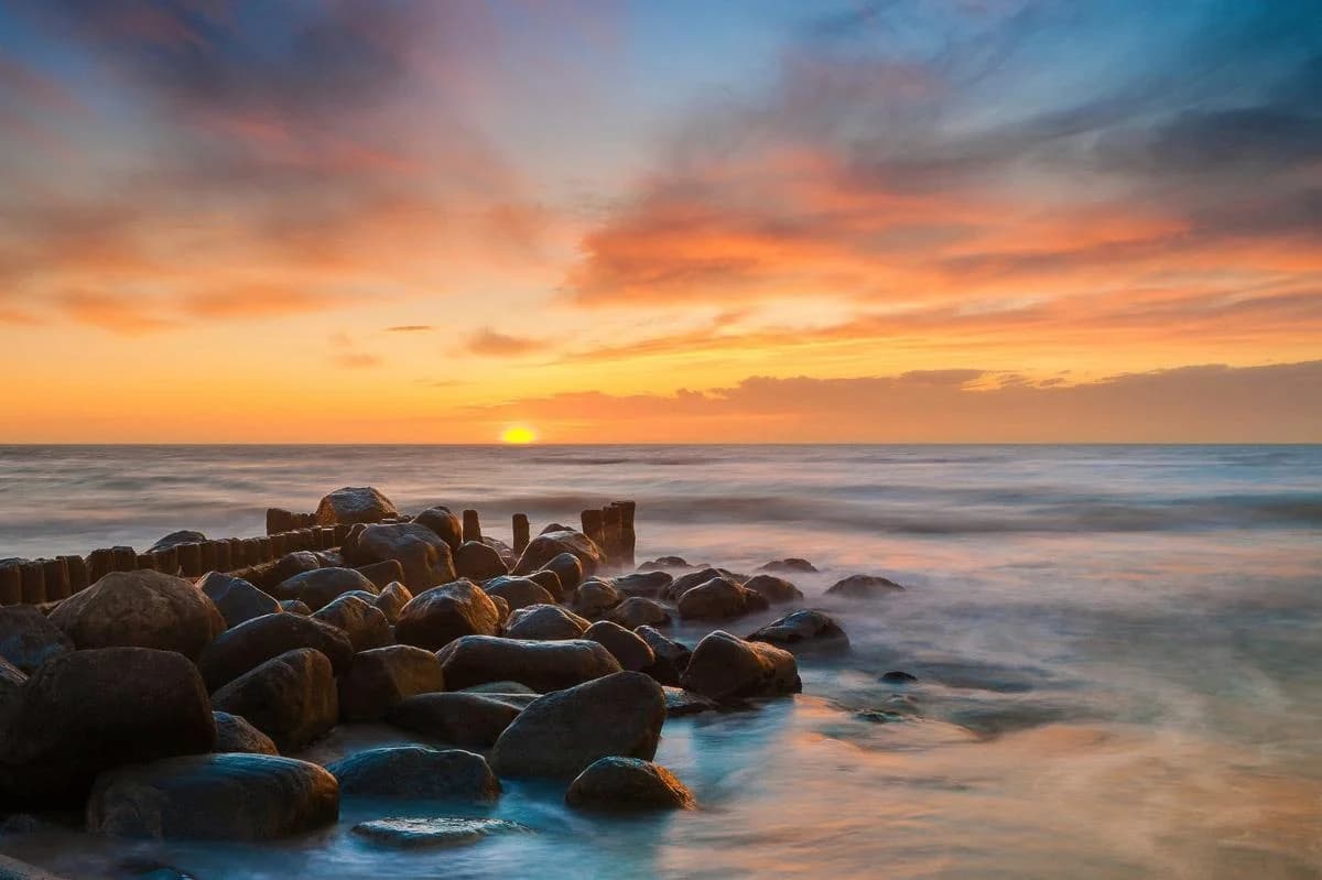 Fototapete PAPERMOON Steine im Meer bunt Vlies
