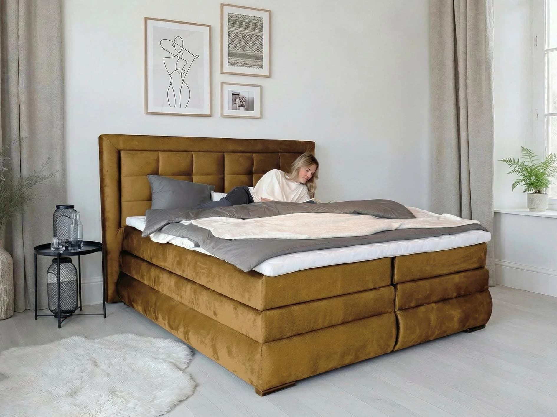 Otto Home Mivva Boxspringbett in 180 mal 200 Zentimetern mit Bettkasten in Weiß und Goldton.